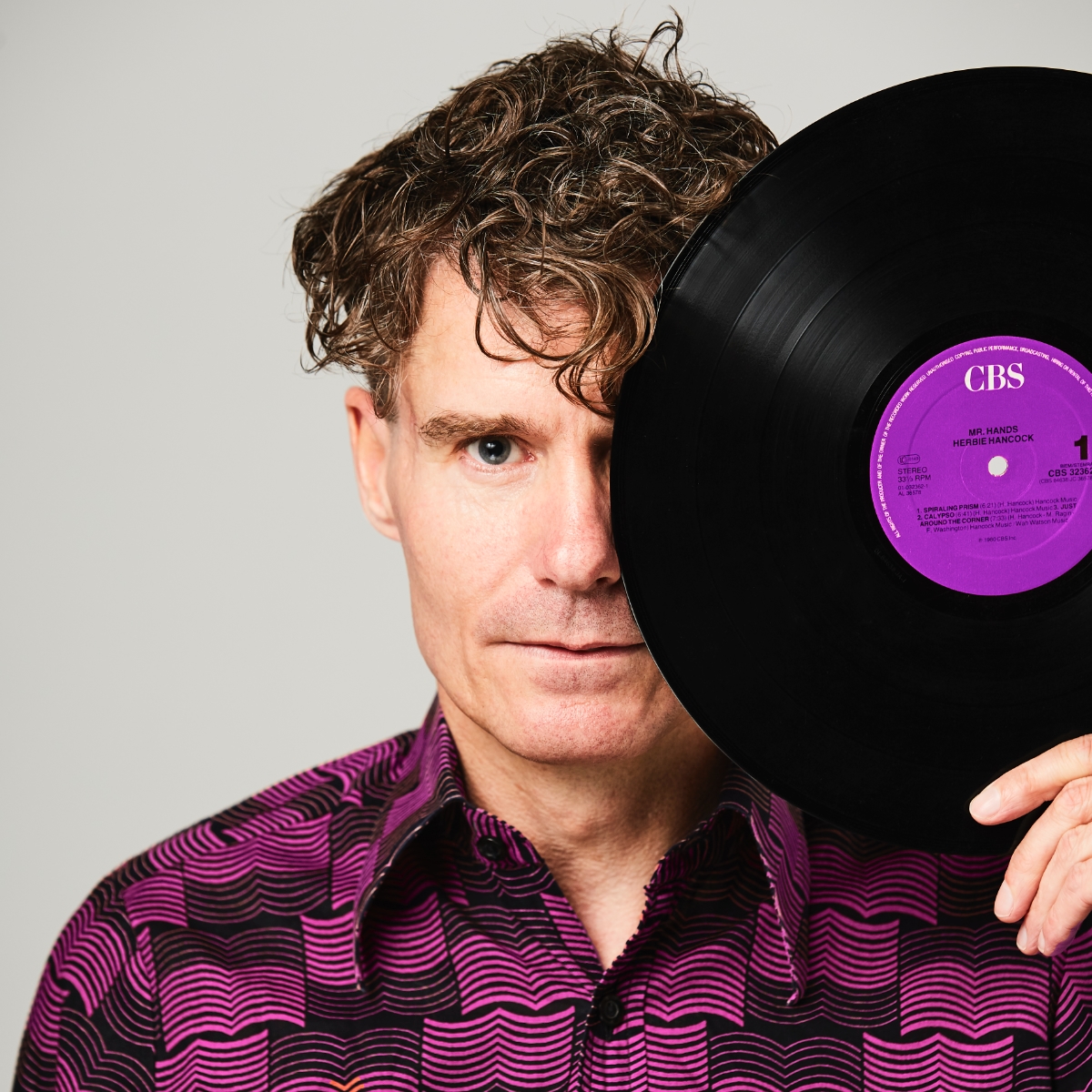 DJ Lars Attack holding a vinyl record